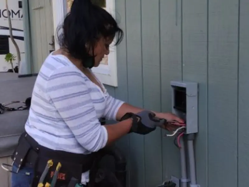 Licensed electrician wiring an exterior subpanel in East Highland Park